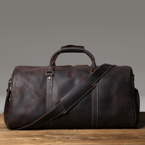 Duffle Bag Heritage - Williams Brothers
Side view of a dark brown leather duffle style travel bag, highlighting its versatile hand and shoulder strap, on a wood floor and a grey background.
https://williamsbrothers.com.au